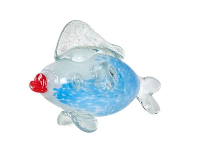 a glass fish that is sitting on a white surface