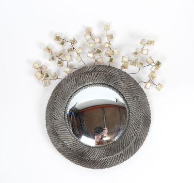 a round mirror with a bunch of flowers on it