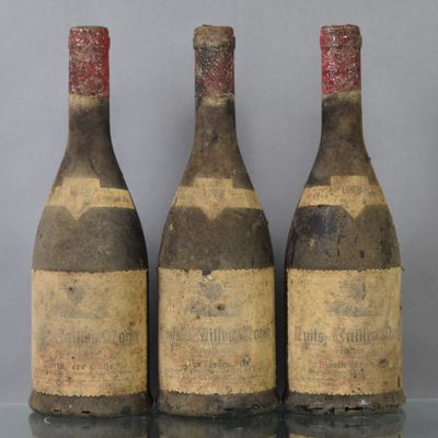 three bottles of wine sitting on top of a table next to each other