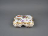 a close up of a small box with flowers on it