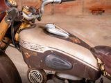 a close up of a motorcycle with a wooden handlebar