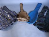 three pairs of gloves and a bag sitting on top of a table