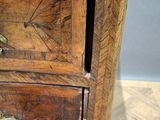 a wooden cabinet with two drawers on top of it