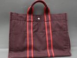 a brown bag with red stripes on it sitting on a gray surface