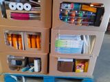 two cardboard boxes with pens and other office supplies on them