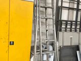 a yellow door and a metal ladder in a room