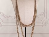 a close up of a mannequin with a necklace on it