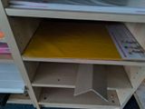 a shelf that has some papers on it in a room