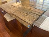 a glass table with a wooden top and white chairs