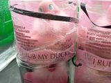 two bags of pink doughnuts sitting on a counter