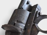 a close up of a gun on a white surface