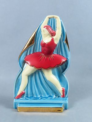 figurine of a ballerina in a red dress on a blue background