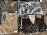 several pairs of pants are wrapped in plastic on a table