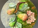a plate with fruit and flowers on it on a table