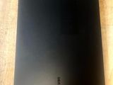 a close up of a black laptop on a wooden table