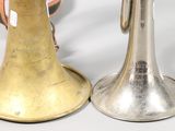 two brass bells sitting next to each other on a table