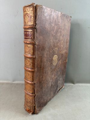 an old book sitting on top of a table next to a wall