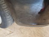 a close up of a car ' s front bumper and tire