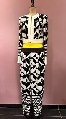 the mannequin is wearing a black and white outfit with a yellow belt