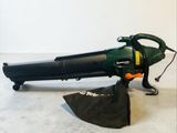 a green and black blow mop sitting on the floor
