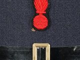 a blue uniform with a red badge on it