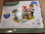 cardboard box with a picture of a child playing with a dinosaur