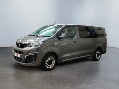 une camionnette grise garée dans une pièce aux murs blancs