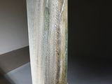 an image of a vase sitting on top of a black marble block