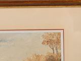 framed watercolor painting of a landscape with trees and a river