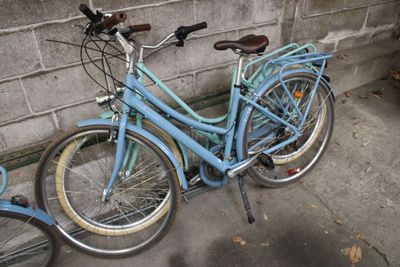 two bicycles parked next to each other on the sidewalk