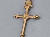 a close up of a cross on a table with a white background