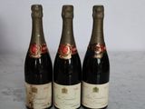 three bottles of wine sitting on a table next to each other