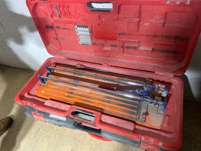 a red tool box with tools in it on the floor