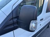 a side view mirror of a van that is parked in a lot