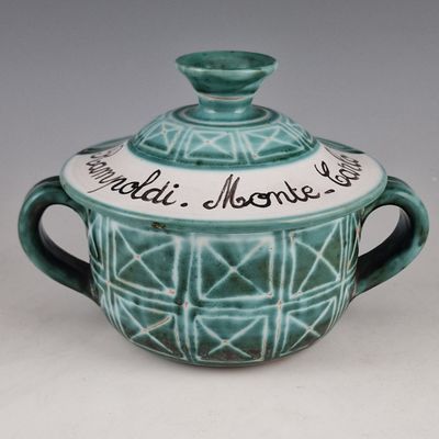 a blue and white bowl with a lid on a table