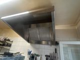 an image of a kitchen with a lot of utensils hanging from the ceiling