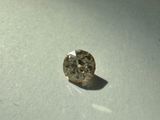 a close up of a diamond on a white surface