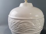 a white vase with a lid sitting on a table