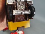 a person holding a toy car in their hand