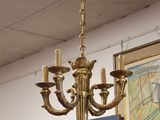 a gold chandelier hanging from a ceiling in a room