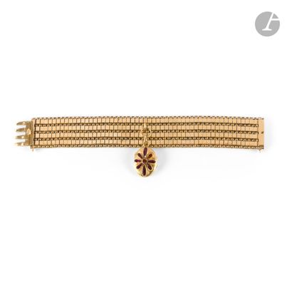 a close up of a gold bracelet on a white background