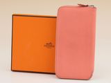 an orange and pink case with a box for a cell phone