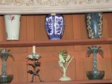 many different vases on a shelf in a room