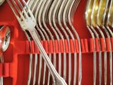 many forks and spoons in a red case