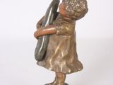 bronze figurine of a girl with a baseball bat on a marble base