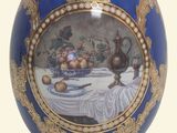 a blue and gold egg with a picture on it