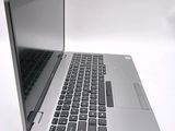 a silver laptop with a black keyboard on a white surface