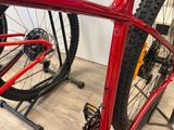 a close up of a red bike on a stand in a store