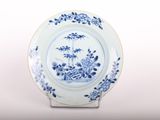 a blue and white plate with a picture of a boat on it