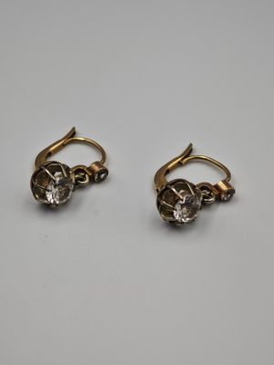 a pair of gold and diamond earrings